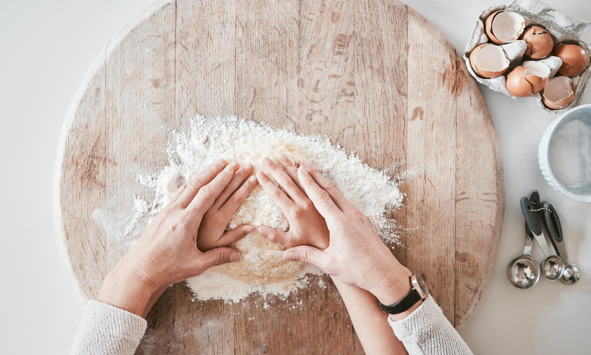 hands kneading dough in natural light