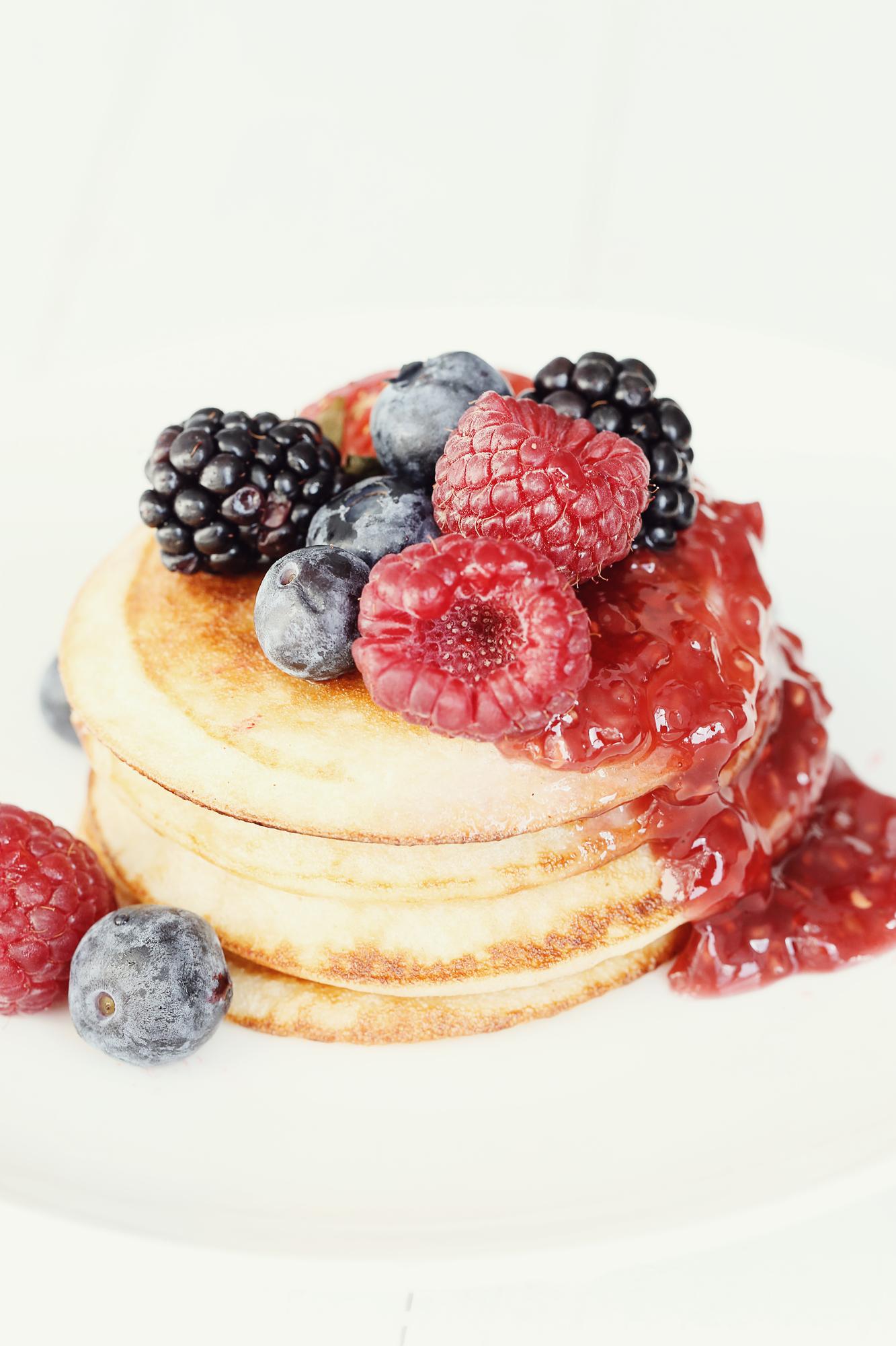 stack of golden pancakes with berries