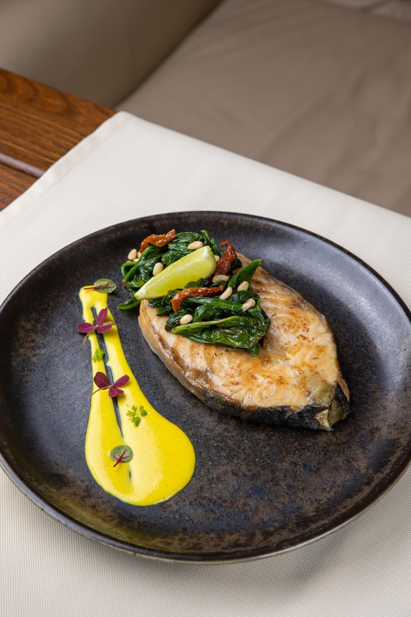 close-up of seared fish on ceramic plate